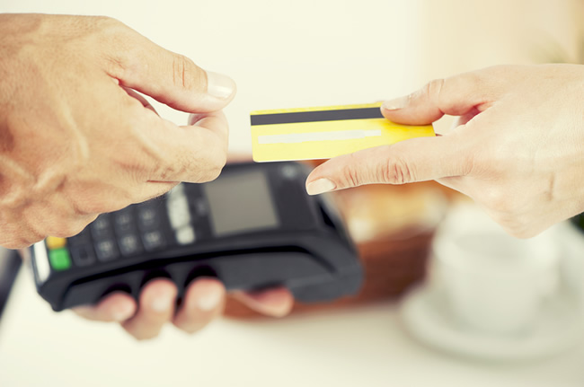 credit card being swiped through a terminal